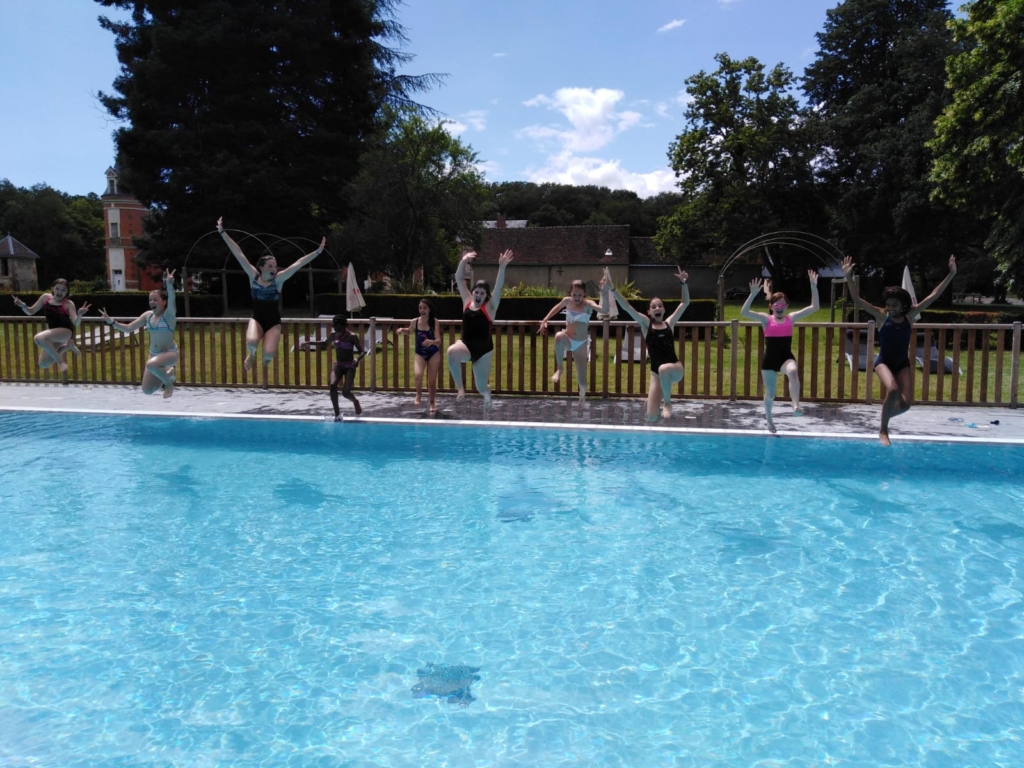 Photo of children jumping into a swimming pool